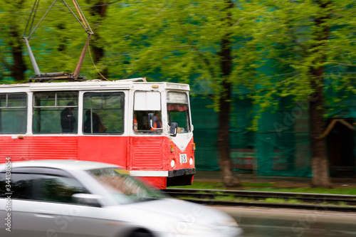 Old tram rides at high speed. City background