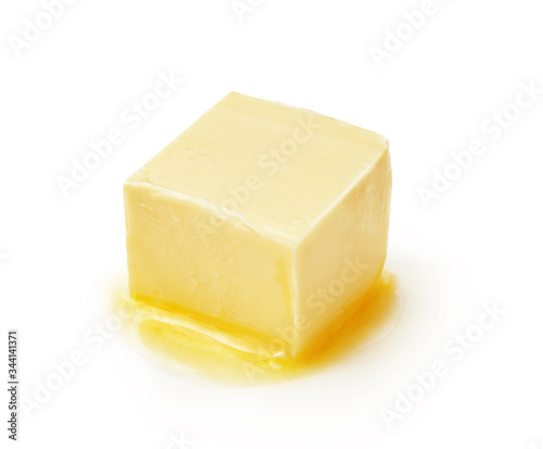A piece of melting butter isolated on white background. Butter cube.