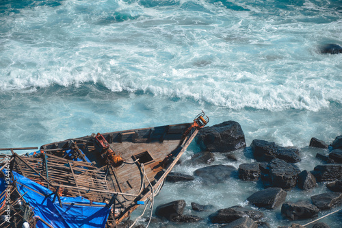 An old shipwreck Abandoned North Korea fishing boat on the sea coast. View from above.