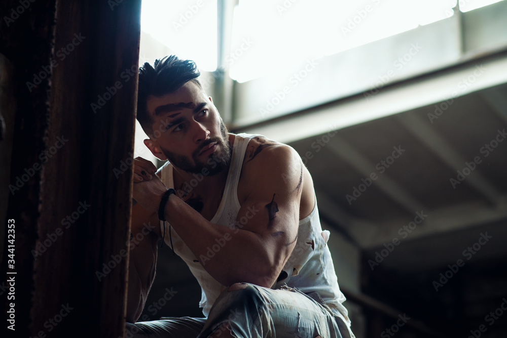 Fototapeta premium man resting after hard physical work, pumped up athletic body, nice caucasian man, bearded guy.