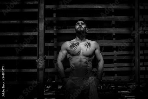 man resting after hard physical work, pumped up athletic body, nice caucasian man, bearded guy.