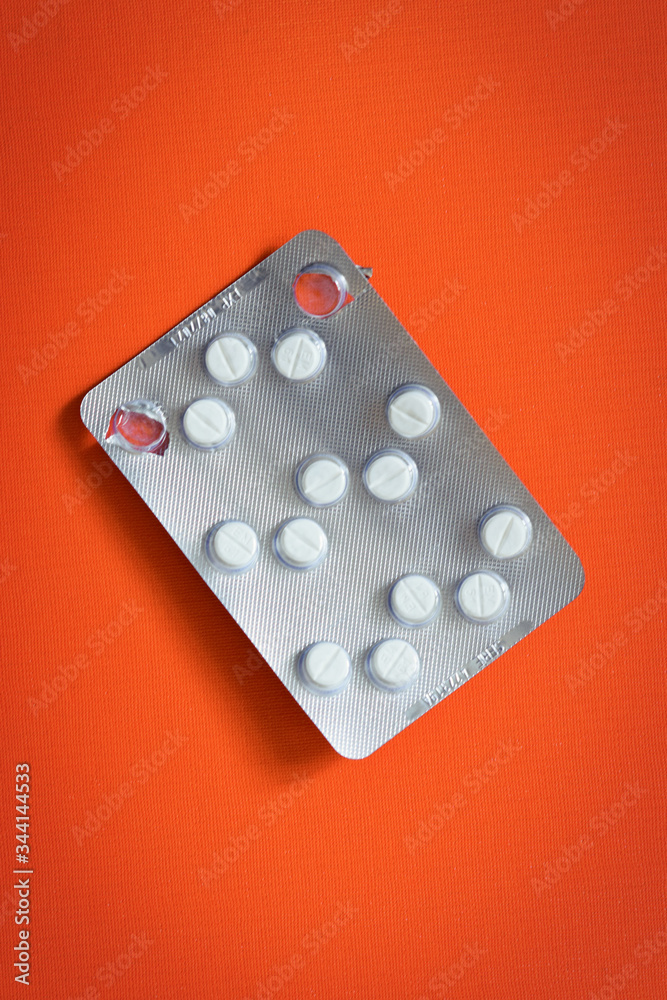 packs of pills opened pills isolated on orange background packs of pills opened pills isolated on orange background