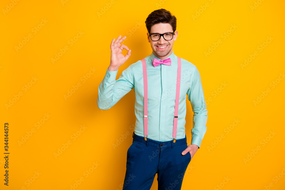 Photo of handsome cool clothes guy boyfriend self-confident person showing  okey symbol express agreement wear specs shirt suspenders bow tie trousers  isolated yellow color background foto de Stock | Adobe Stock