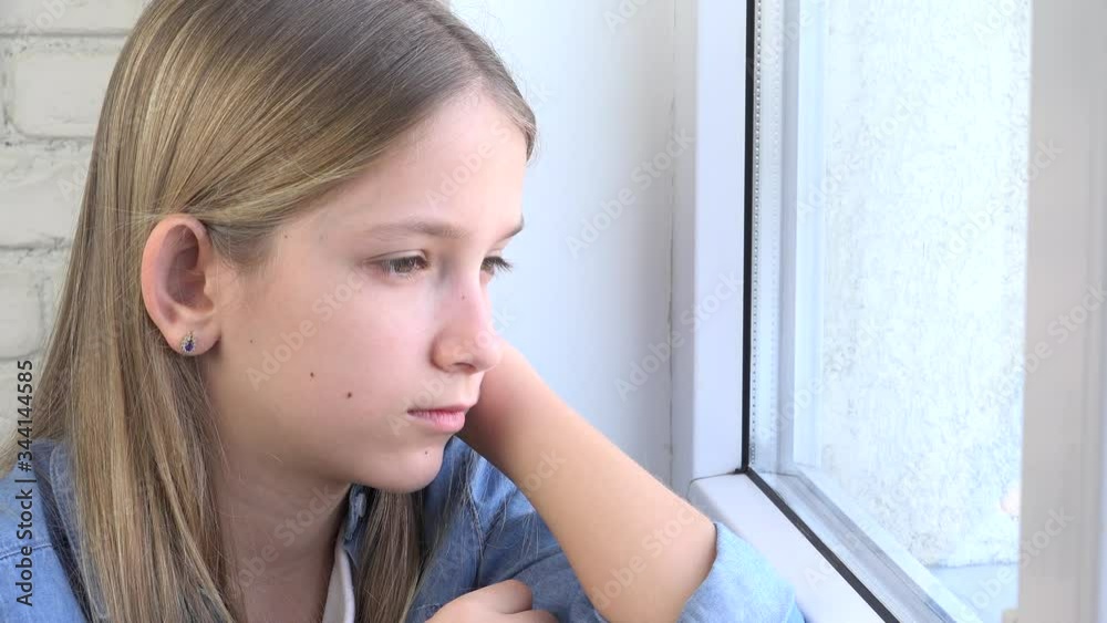 Sad Kid Looking on Window, Unhappy Child, Bored Thoughtful Girl, Sadness on Teenager Face, Isolated People Quarantined at Home due to Coronavirus Crises Sad Kid Looking on Window, Unhappy Child, Bored Thoughtful Girl, Sadness on Teenager Face, Isolated People Quarantined at Home due to Coronavirus Crises
