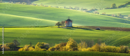 Spring landscape with old mill on hills. Green hills at sunset, South Moravia Czech Republic