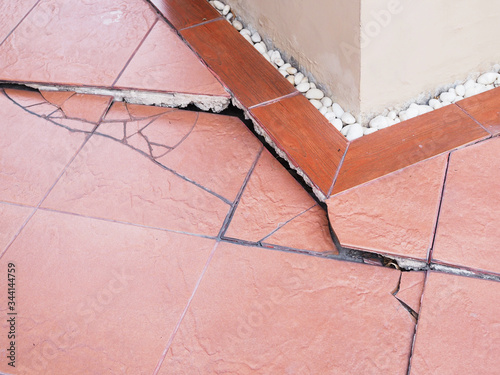Collapsed house structure problems with cracked floor tiles, house damaged with soil subsidence.