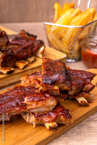 Bbq spare ribs with french fries and barbecue sauce