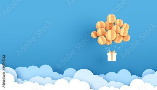 Balloon yellow floating on sky. Delivery service with Gift Box on air blue background.happy new years and merry Christmas.Festival transportation concept.Creative paper cut and craft style vector