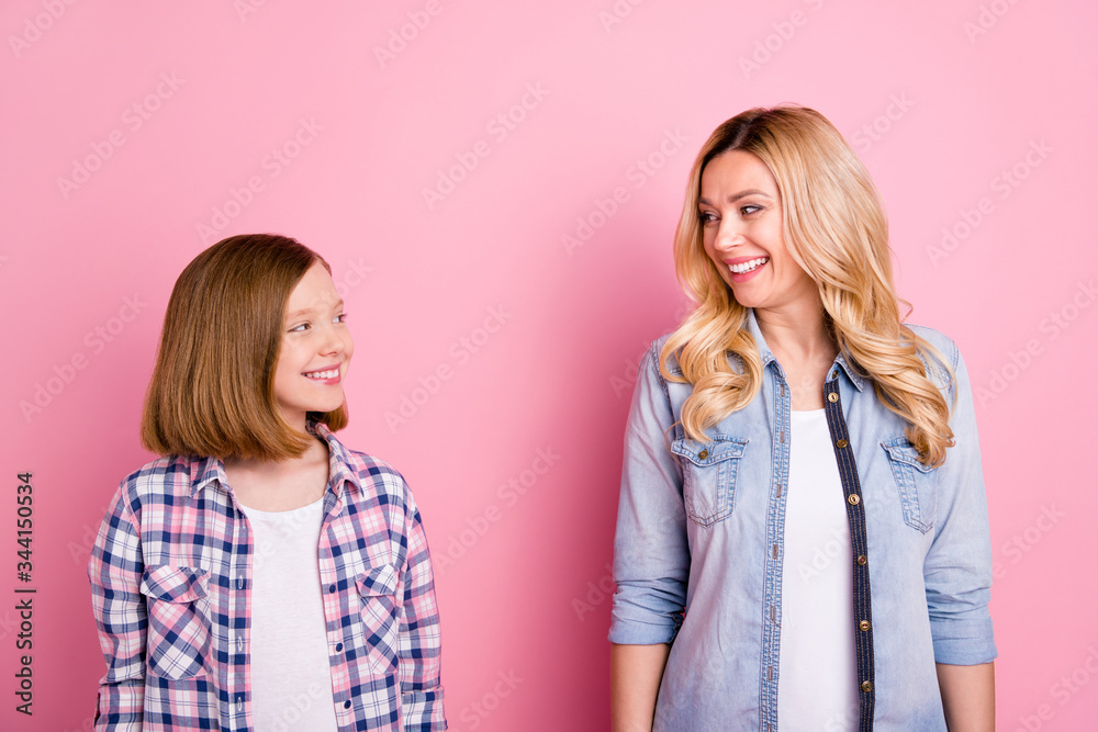 Portrait of charming candid woman look at her small daughter enjoy summer rest relax wear checkered plaid denim jeans shirt isolated over pastel color background Portrait of charming candid woman look at her small daughter enjoy summer rest relax wear checkered plaid denim jeans shirt isolated over pastel color background