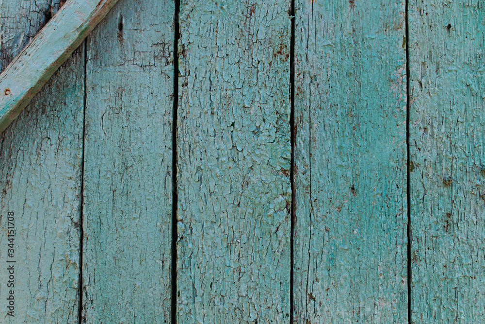 Close-up view of green painted pale and worn hardwood planks surface as background image. Abstract background Close-up view of green painted pale and worn hardwood planks surface as background image. Abstract background