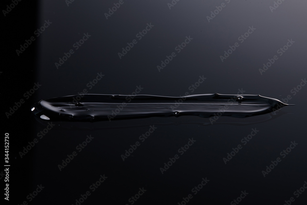 Transparent gel cream texture with a black background.