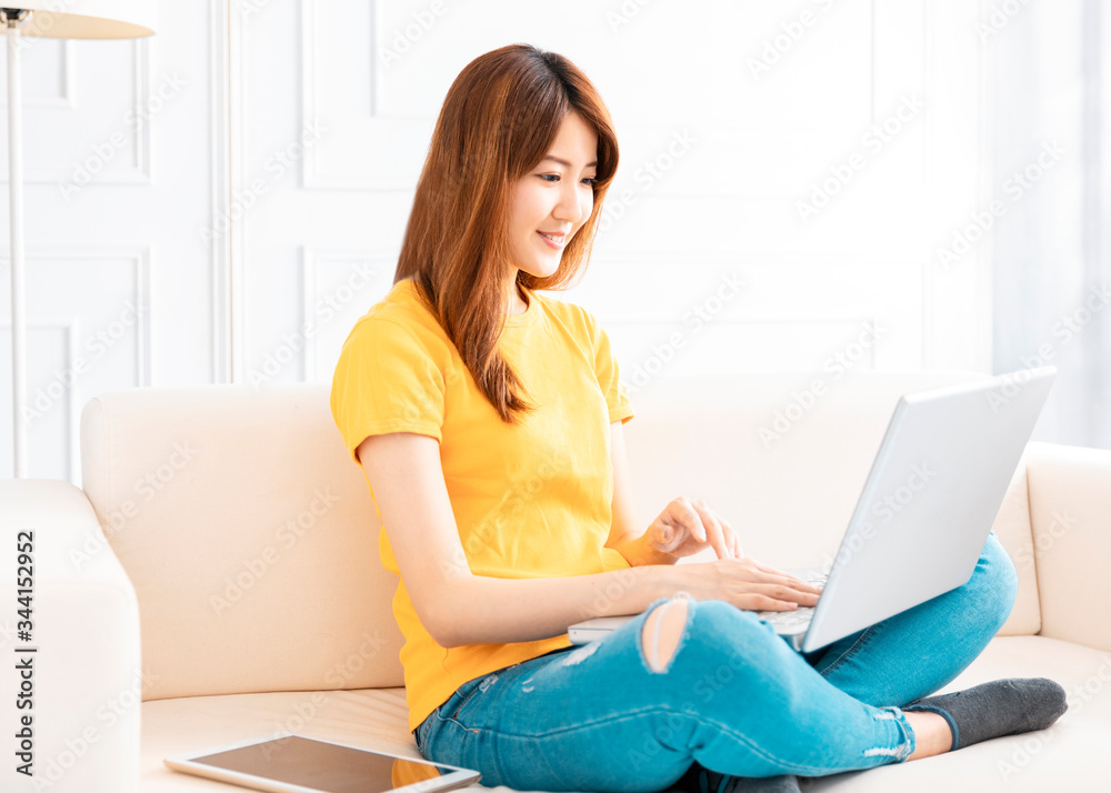 smiling young Woman working on laptop at home smiling young Woman working on laptop at home