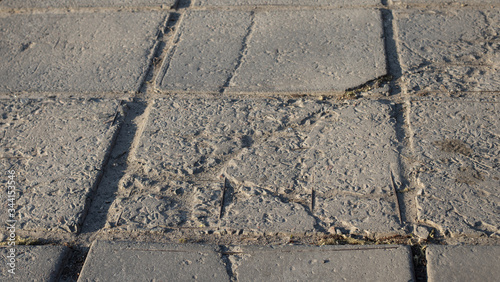 The texture of the broken road. Old building blocks. Background for screensaver monitor
