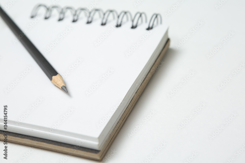 Selective focus of Pencils and notepads on white background Selective focus of Pencils and notepads on white background