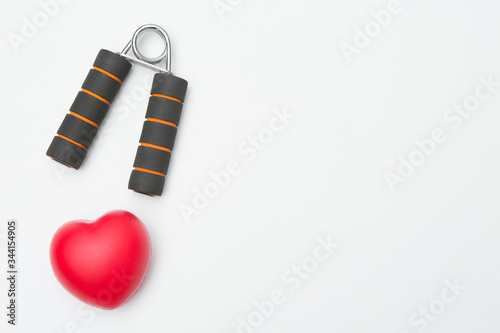 Hand grip and Heart shaped squeeze ball for hand muscle exercise  on white background and copy space