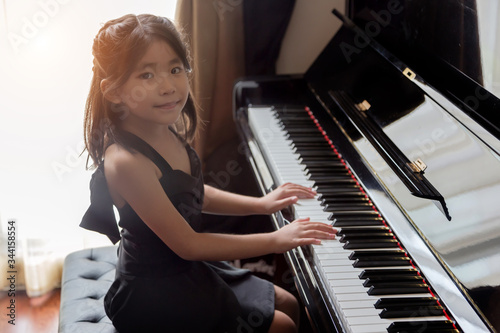 asian girl kids playing piano have talent and practice for up musical skill