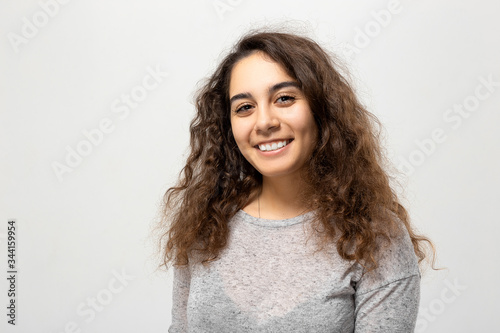 Beautiful young woman portrait. Indoor portrait of beautiful brunette with shaggy hairstyle