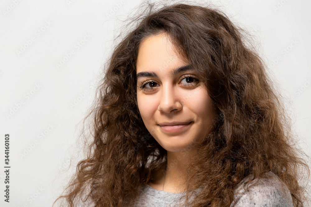 Beautiful young woman portrait. Indoor portrait of beautiful brunette with shaggy hairstyle Beautiful young woman portrait. Indoor portrait of beautiful brunette with shaggy hairstyle