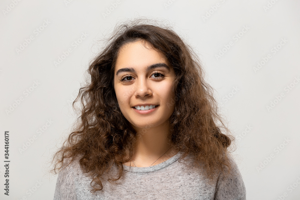 Beautiful young woman portrait. Indoor portrait of beautiful brunette with shaggy hairstyle