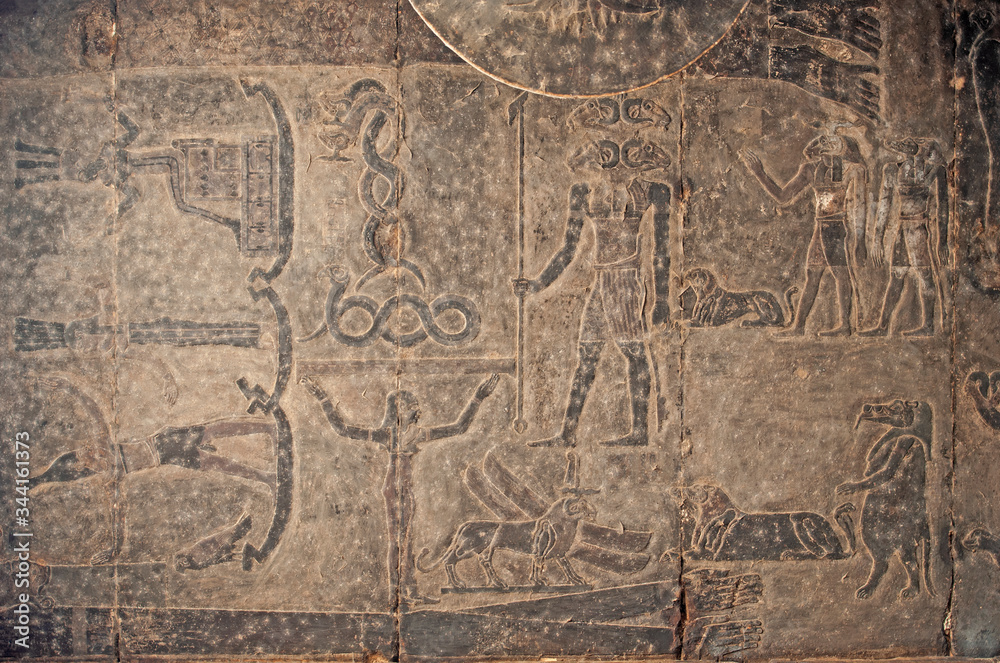 Hieroglyphic carvings on an ancient egyptian temple wall