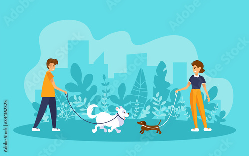 Man and woman walking in a park, holding their dogs on leashes and looking at each other