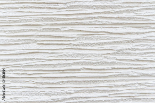 White striped background. High detailed fragment of white stone wall.
