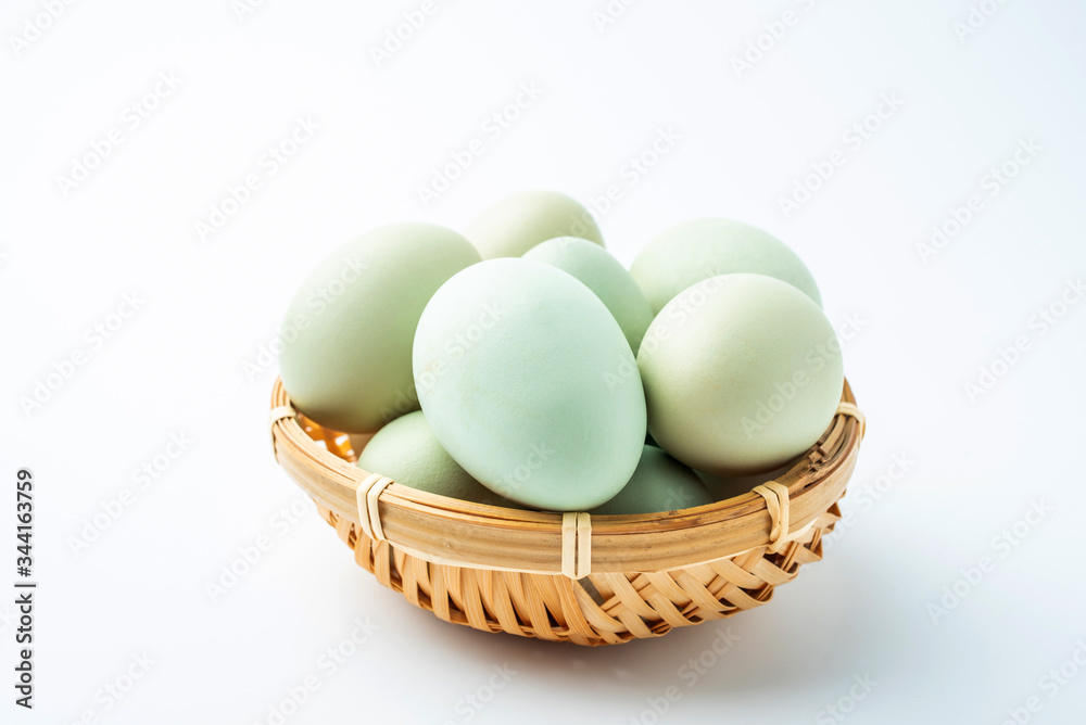 Black eggs in green shell on white background Black eggs in green shell on white background