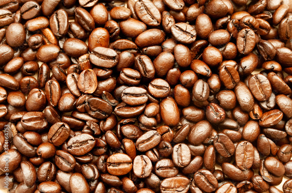 many brown and golden coffee beans, fried lodges scattered across the table. many brown and golden coffee beans, fried lodges scattered across the table.