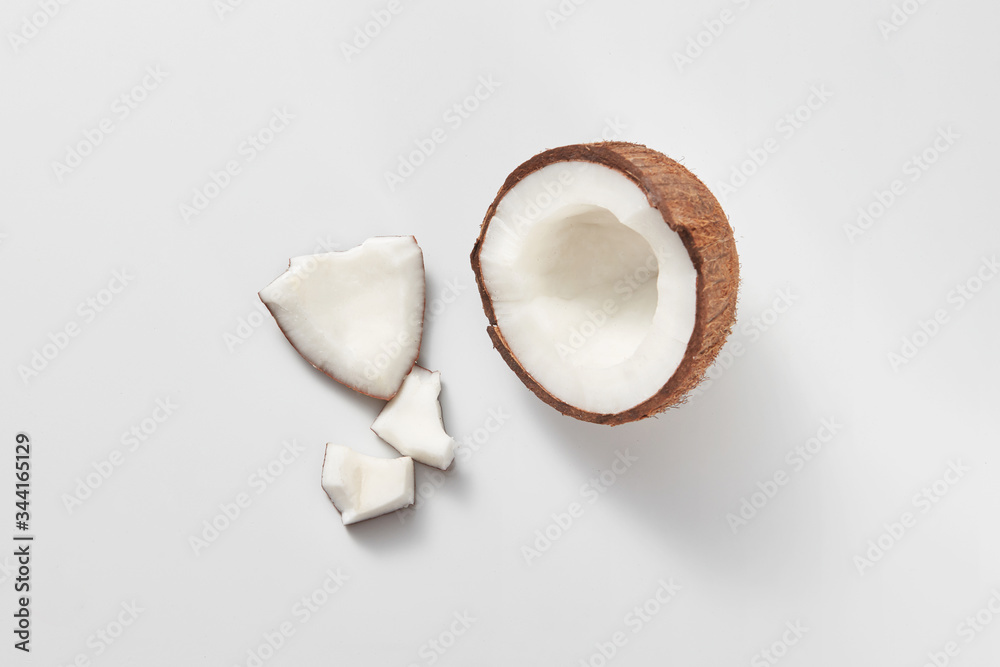 Top view of fresh natural organic coconut's half on a light grey background. Top view of fresh natural organic coconut's half on a light grey background.
