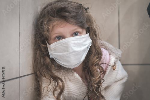 cute little girl wearing a surgical mask