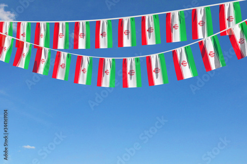 Iran flag festive bunting hanging against a blue sky. 3D Render