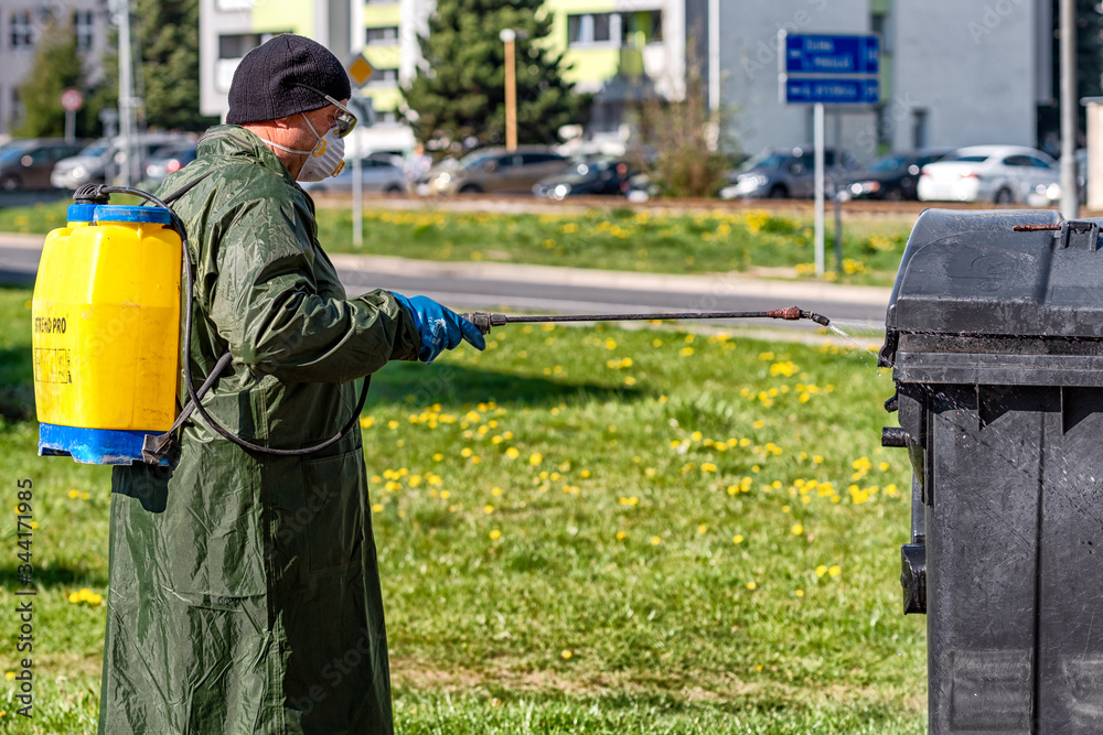 Disinfecting corona virus COVID-19 by man in protective suit Disinfecting corona virus COVID-19 by man in protective suit
