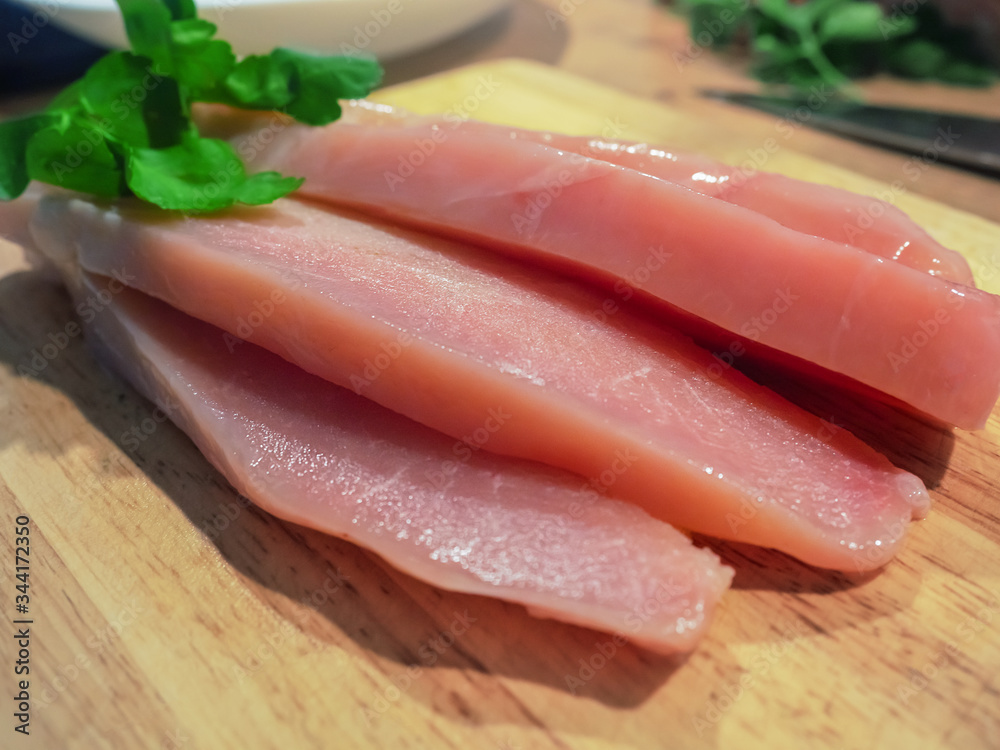 pieces of raw chicken on a cutting board pieces of raw chicken on a cutting board