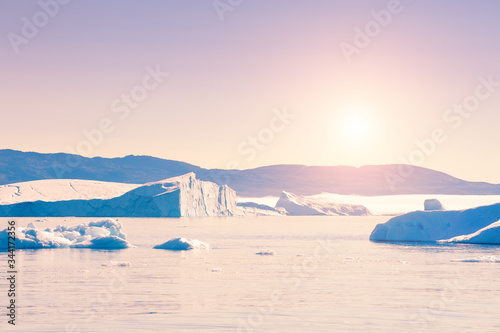 Big iblue cebergs in Ilulissat icefjord at sunset, western Greenland. photo