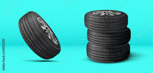 A stack of summer and winter tires. Tires service. Car tire set. Replacement tires for the season. Tire and wheel of automobile wheel on a background.