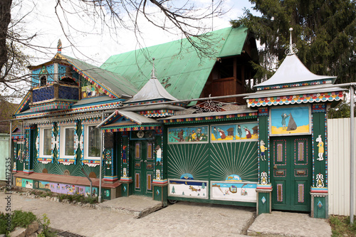 Volkhin's rural wooden house with ornamental carved windows in Beryozovsky town, Sverdlovsk region, Russia. Russian traditional national folk style in architecture photo