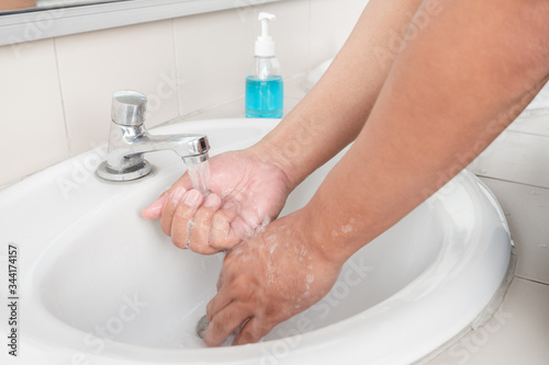 Men's hands wash their hands with soap clean hands in the tub with soap, personal hygiene