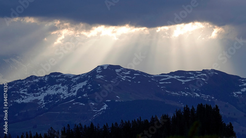 beautiful morning on the mountains with sunbeams and clouds and view to the alps