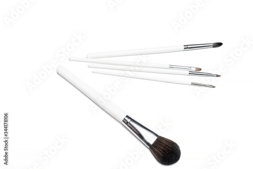 Professional makeup brushes isolated on a white background.