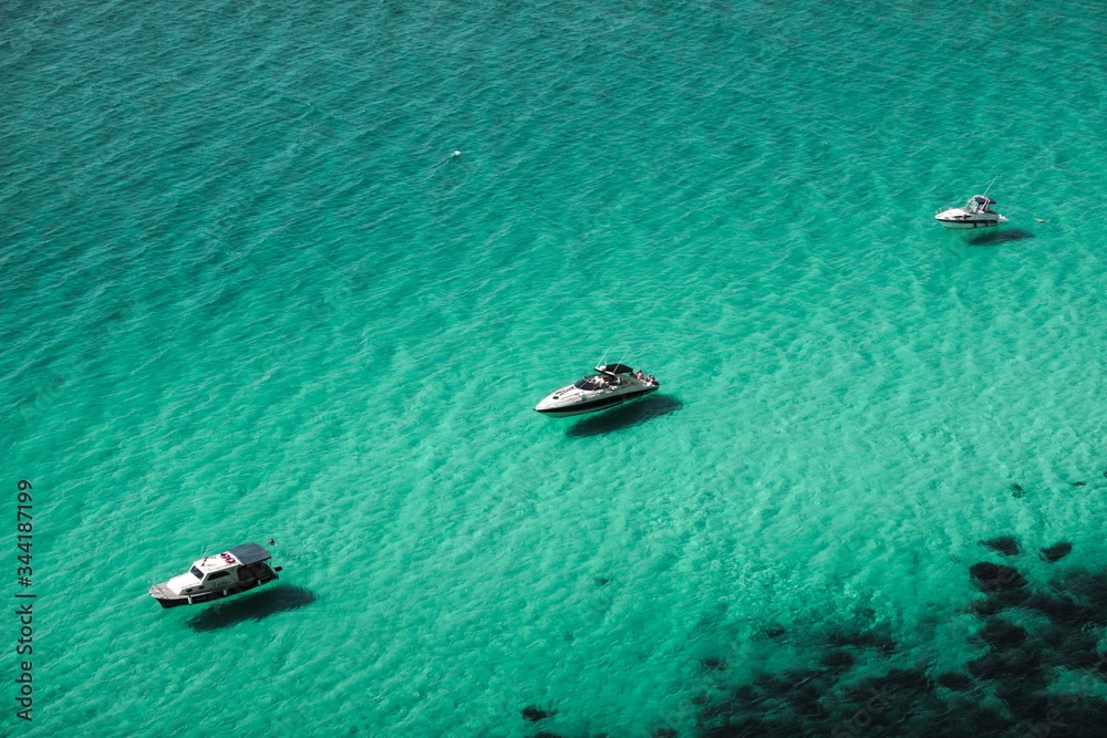 Fototapeta premium Three boats on turquoise sea
