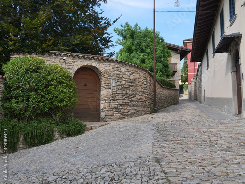Empty narrowl cobblestone street photo