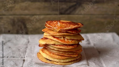 hot pancakes are poured with maple syrup. sweet flapjacks for Breakfast