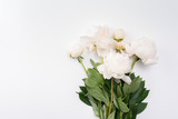 Bouquet of white peonies on a light background.