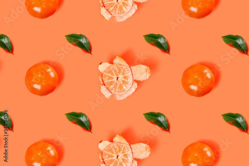 Fototapeta Naklejka Na Ścianę i Meble -  Mandarin pattern on bright orange background. Minimal flat lay concept.