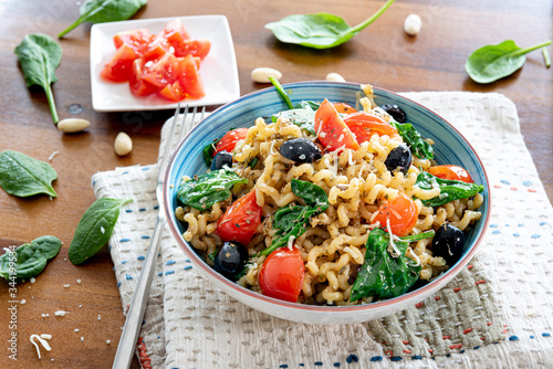 Fusilli lunghi ,cherry tomato, black olive and spinach, mediterranean diet food.