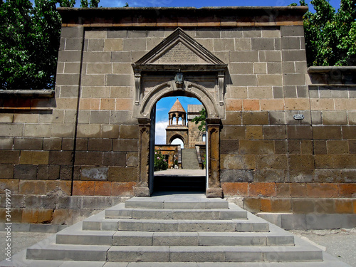 View on the ancient Armenian church of Saint Hripsime through the arc of the main gate, Vagharshapat, Armenia. There are some Armenian writing above entrance photo