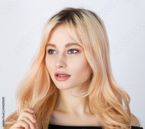 Portrait of a blond girl with dark roots.