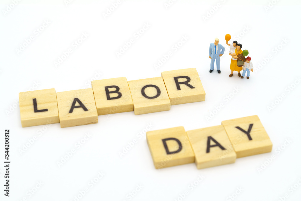 Miniature people standing with wood word Labor Day using as background Universal day concept and Health Day concept with copy space for your text or design. Miniature people standing with wood word Labor Day using as background Universal day concept and Health Day concept with copy space for your text or design.