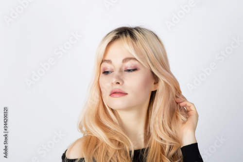Blonde girl with pink eye shadows on her face.