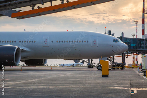 Big gray plane at the airport terminal